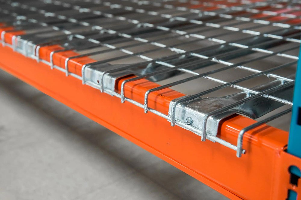 Wire mesh decking dropped into pallet rack beam pair — welded steel wire grid with step channel waterfall support