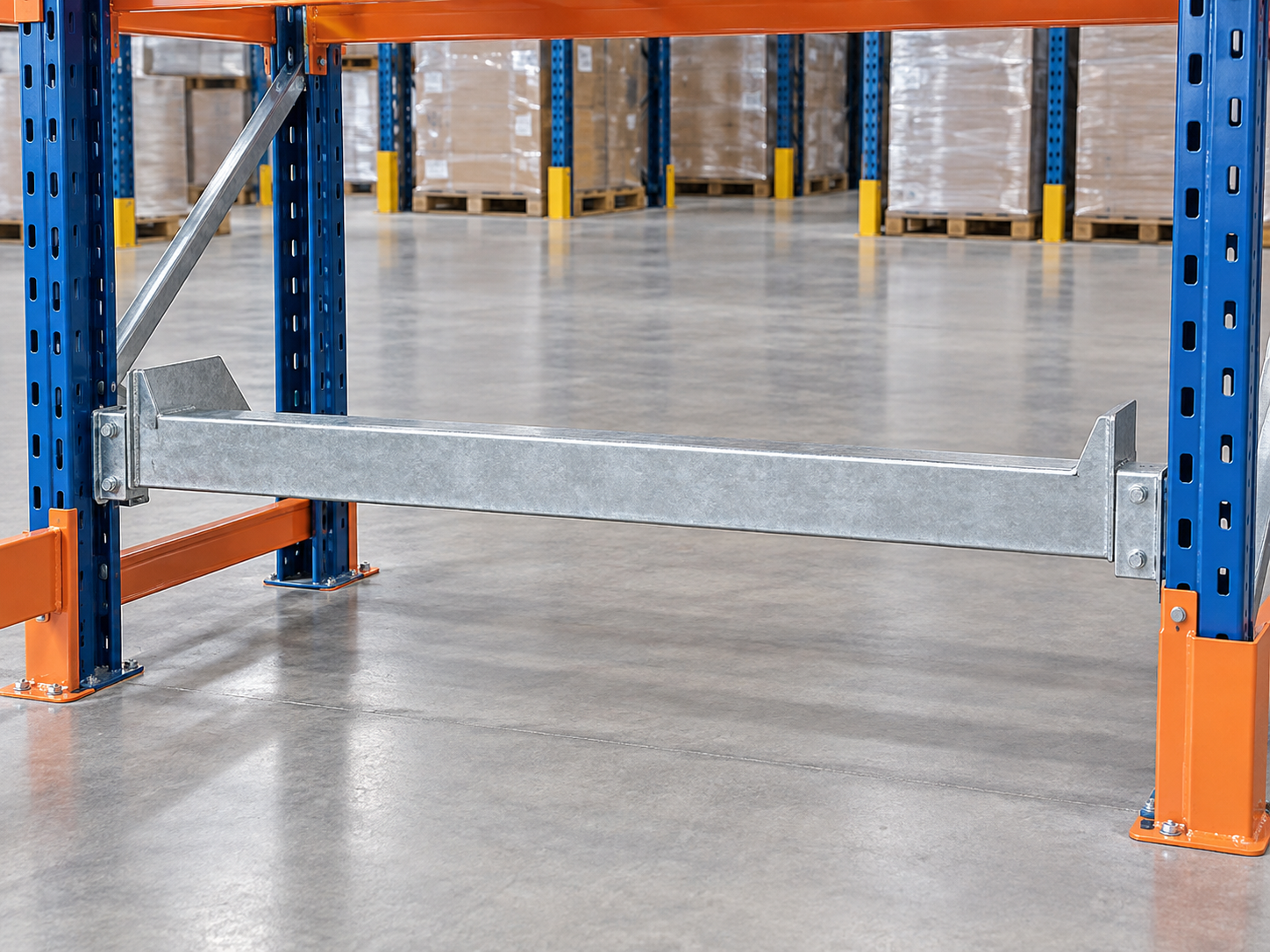 Rear pallet stop mounted across a pallet rack bay